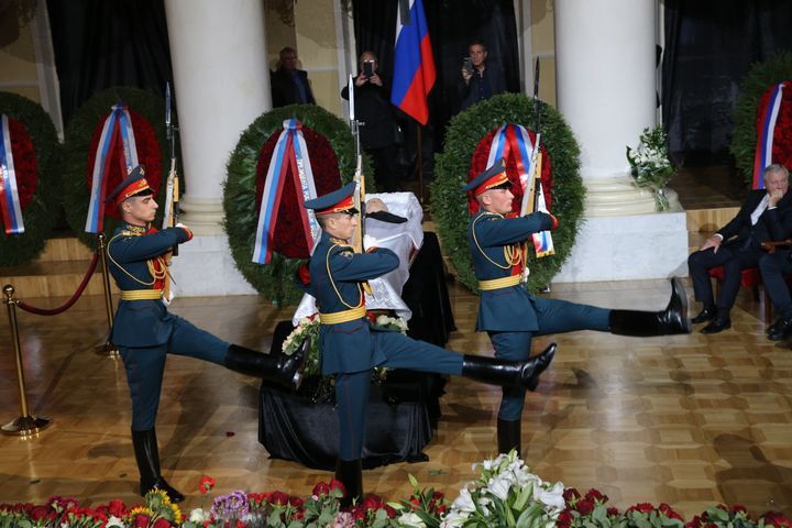 Russian Presidential Regiment soldiers march adjacent   the coffin with assemblage  of the precocious   USSR President Mikhail Gorbachev.
