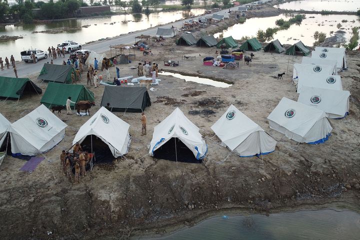 This aerial photograph taken on September 3, 2022, shows the Pakistani army as they arrive to help flood-affected people at a makeshift camp after heavy monsoon rains at Sohbatpur in the Jaffarabad district of the Balochistan province. Monsoon rains have submerged a third of Pakistan, claiming at least 1,300 lives since June and unleashing powerful floods that have washed away swathes of vital crops and damaged or destroyed more than a million homes.