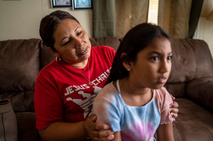 Marcela Cabralez straightens the hair of her granddaughter, Jalissa Ybarra at their home on Monday, Aug. 30, 2022 in Uvalde, Texas. Jalissa, 9, was in the cafeteria of Robb Elementary when a shooter came into the school and opened fire, killing 19 students and 2 teachers. Jalissa has struggled with nightmares in the months since the shooting and expressed nervousness about going back to school.
