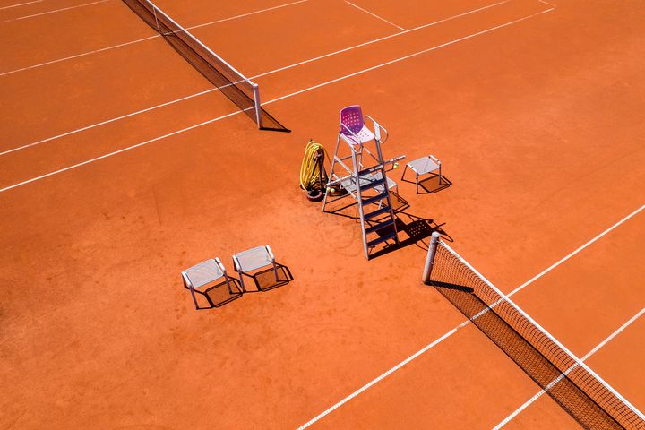 Tennis court and sports equipment viewed from directly above.