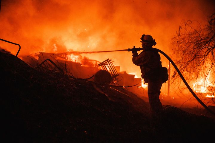 A firefighter takes a hose to a burning spot   portion    battling the Fairview Fire connected  Sept. 5, 2022, adjacent   Hemet, Calif. 