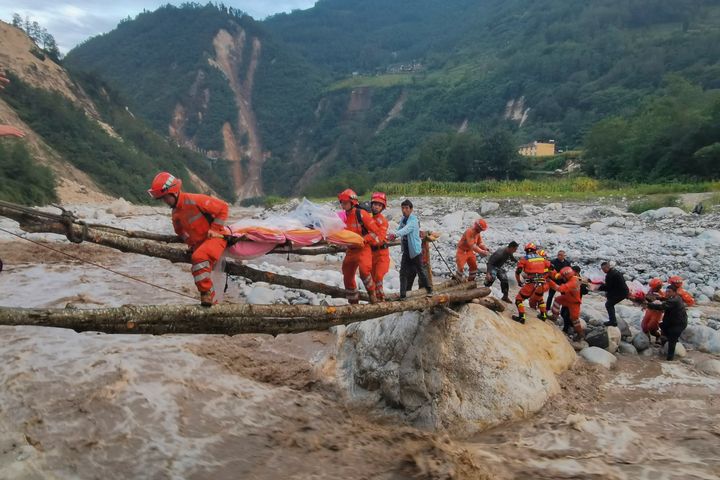In this photo released by Xinhua News Agency, rescuers transfer survivors across a river following an earthquake in Moxi Town of Luding County, southwest China's Sichuan Province on Sept. 5, 2022. Dozens of people were reported killed and missing in an earthquake that shook China's southwestern province of Sichuan on Monday, triggering landslides and shaking buildings in the provincial capital of Chengdu, whose 21 million residents are already under a COVID-19 lockdown. 