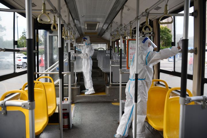 Staff members wearing personal protective equipment (PPE) disinfect a bus at a bus station on Sep. 5, 2022, in Chengdu, Sichuan Province of China.