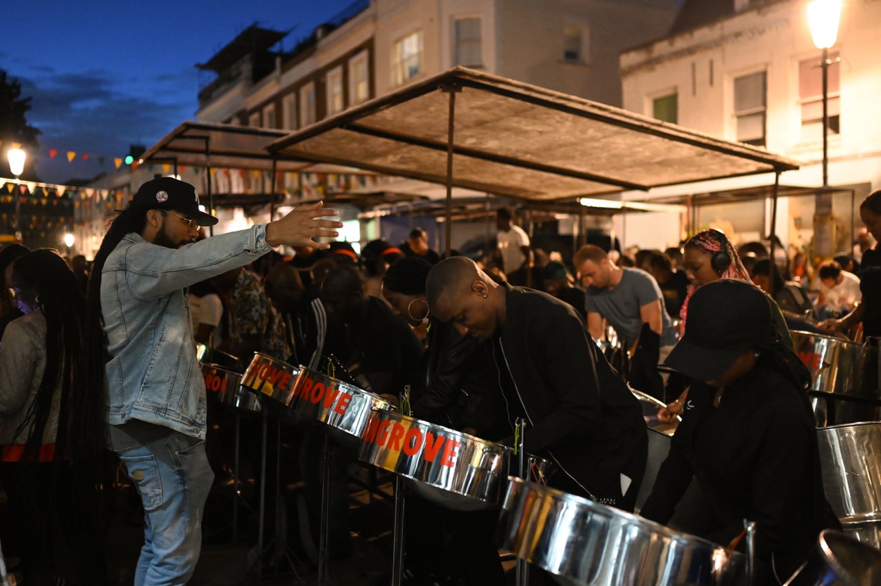 Andre White, the Mangrove Steelband's arranger, conducts the band's rehearsal on All Saints Road.