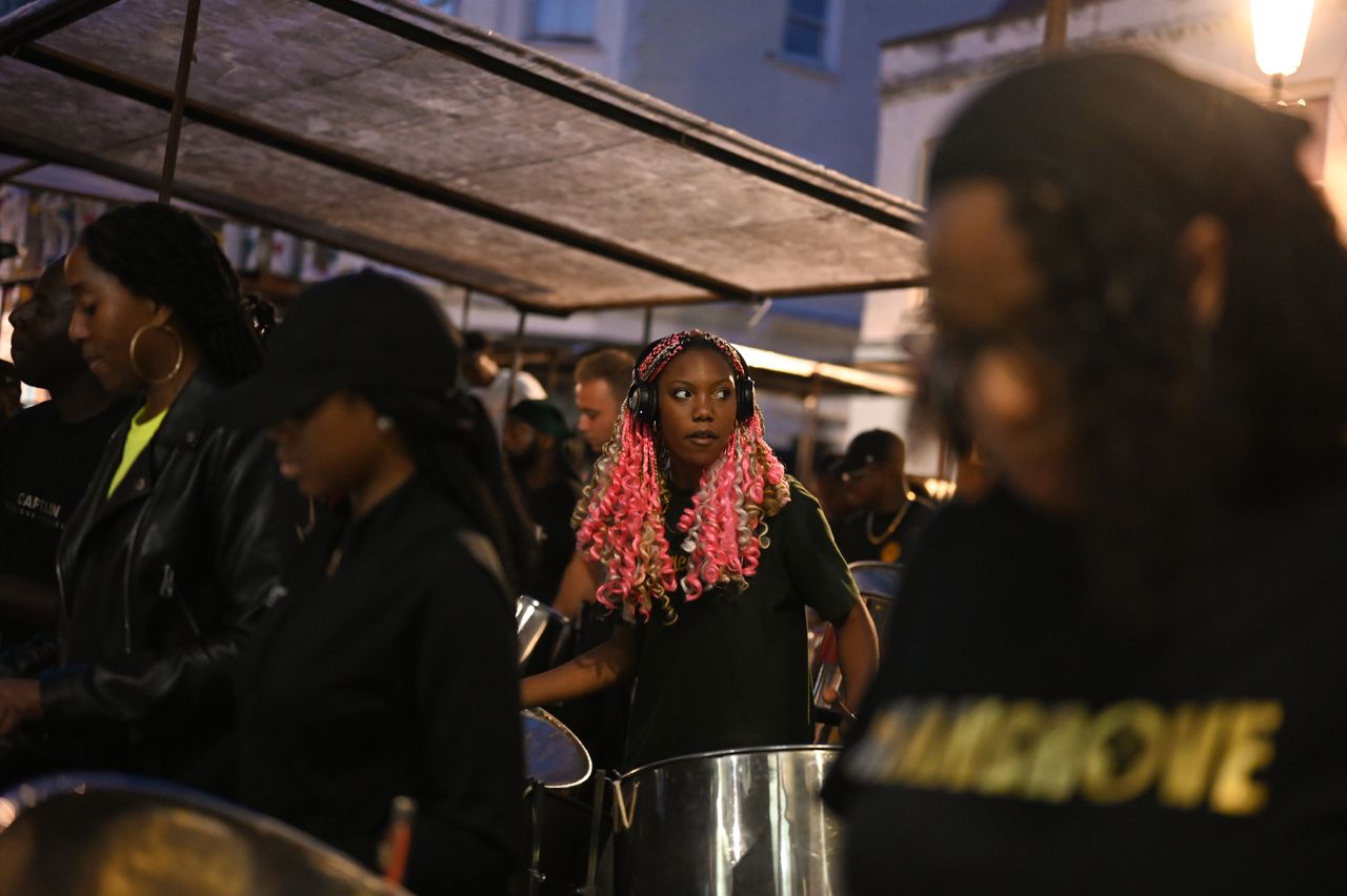Romaya rehearses as part of the Mangrove Steelband. This is the band's first outdoor rehearsal this year, performing in front of a crowd on All Saints Road. On this night, the band's competing song, "Mash Up" by Blaxx, is revealed ahead of the 2022 Panorama Steel Pan competition. "Carnival is a place where I know I can truly be myself, wear what I want, dance when I want, without being judged," Romaya says. "I have the utmost respect for the people who make Carnival happen every year."