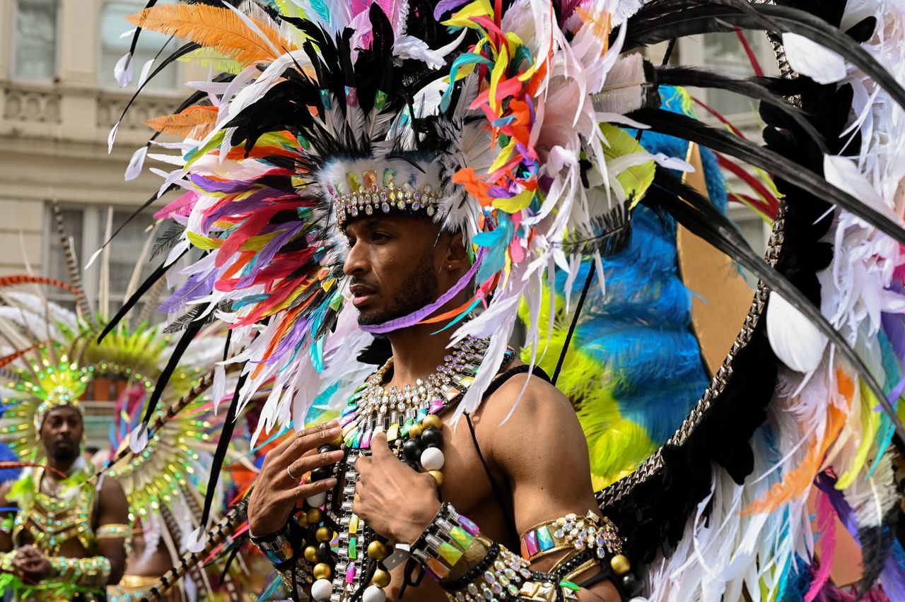 A costumed masquerader participates in the Notting Hill Carnival parade.