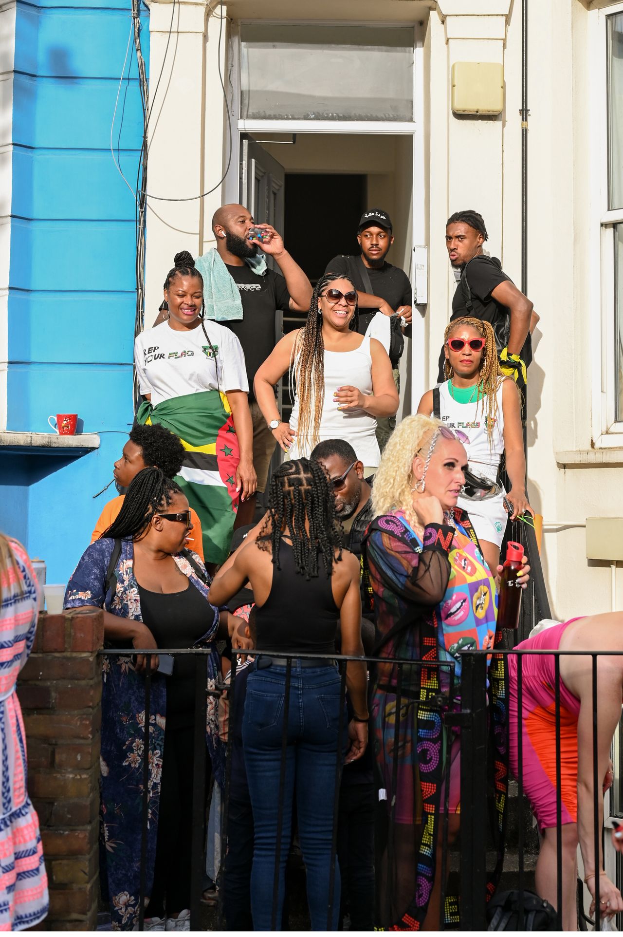 Onlookers watch the Notting Hill Carnival parade go down Ladbroke Grove.