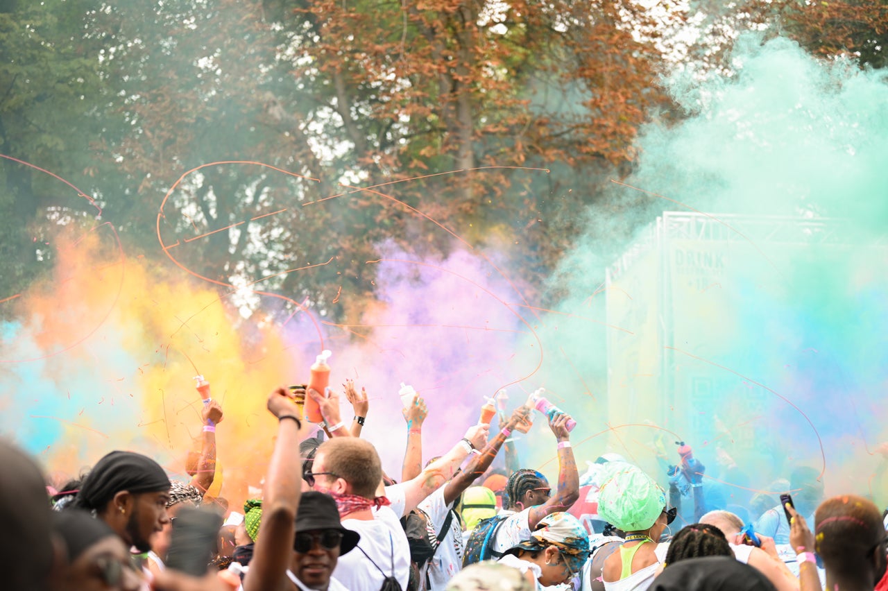 Colorful powders and paints are released in the air during Dutty Mas.