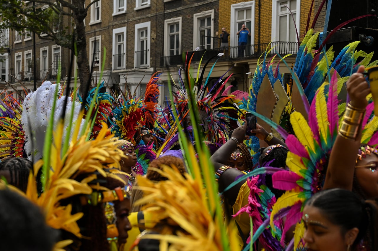 A sea of masqueraders walk along the route of the Notting Hill Carnival parade down Ladbroke Grove.
