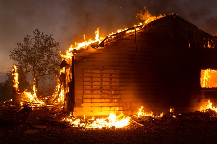 A property burns in Riverside County amid the intense heat wave.