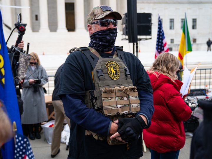 FILE: A member of the right-wing group Oath Keepers stands guard in front of the U.S. Supreme Court Building on January 5, 2021. Over two dozen people associated with the group have been charged in connection to the Jan. 6 attack.