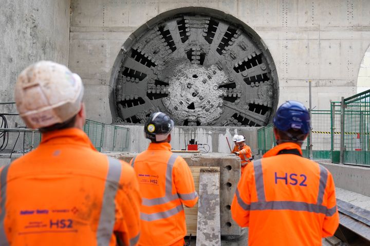 Construction workers for HS2 stand by the 2,000-tonne tunnel boring machine named 'Dorothy'.