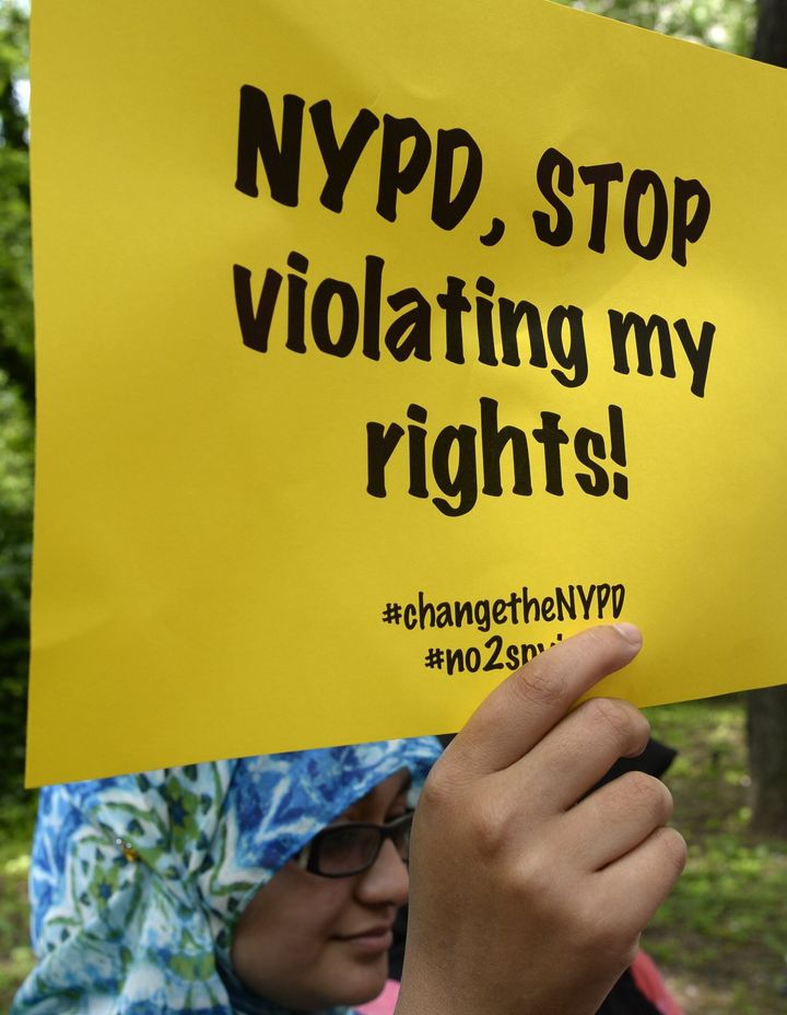 Demonstrators listen to residents and civil rights and legal advocates hold a press conference on June 18, 2013, in New York to discuss planned legal action challenging the city police department's surveillance of businesses frequented by Muslim residents and area mosques.