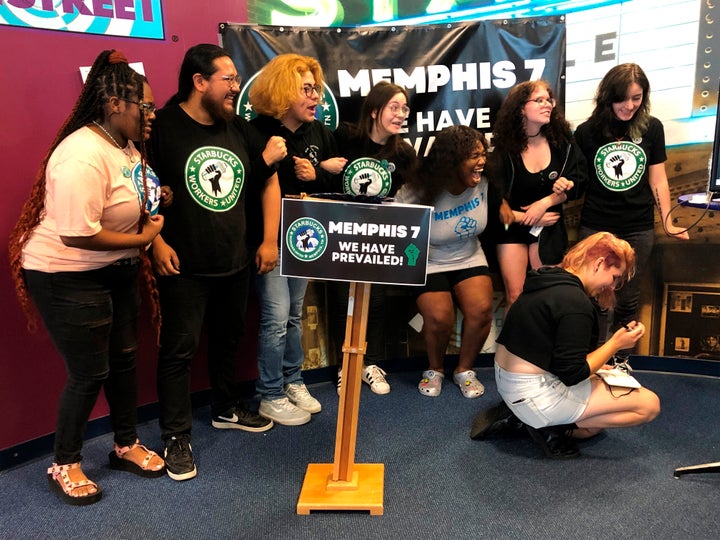 A group of fired Starbucks employees celebrate the result of a vote to unionize one of the coffee company's locations in Memphis back in June. Starbucks said it will reinstate seven employees who were fired in February after leading an effort to unionize their Memphis store. 