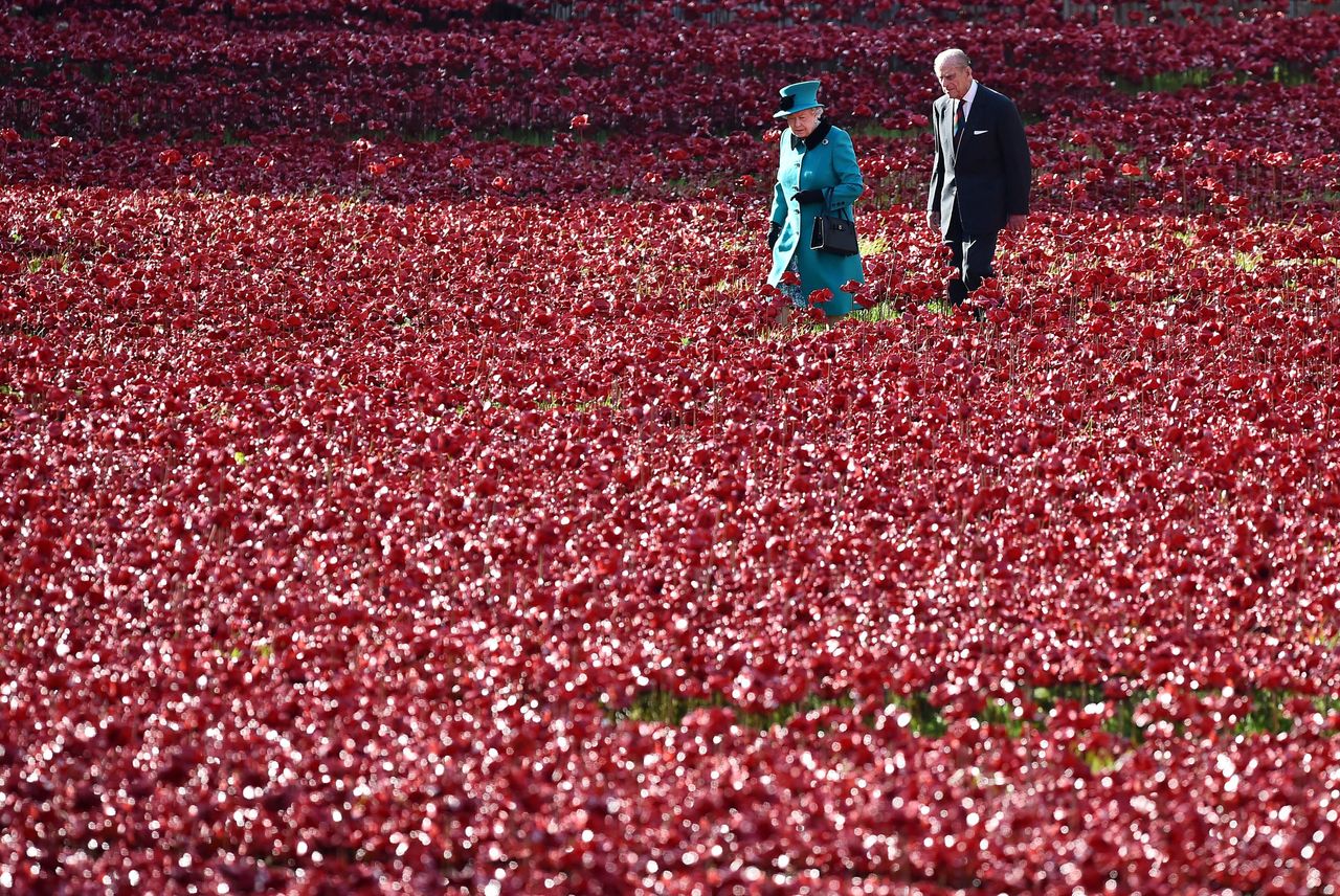 Queen Elizabeth II and husband Prince Philip, Duke of Edinburgh, visit the Tower of London's poppy installation on October 16, 2014.