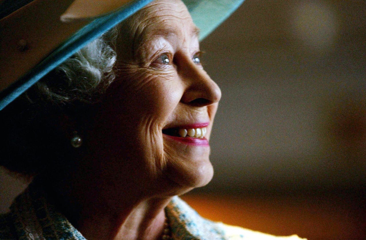 Queen Elizabeth II meets British Airways dignitaries during a visit to Heathrow Airport in 2004 to mark the 10th anniversary of UNICEF and British Airways' Change for Good program.