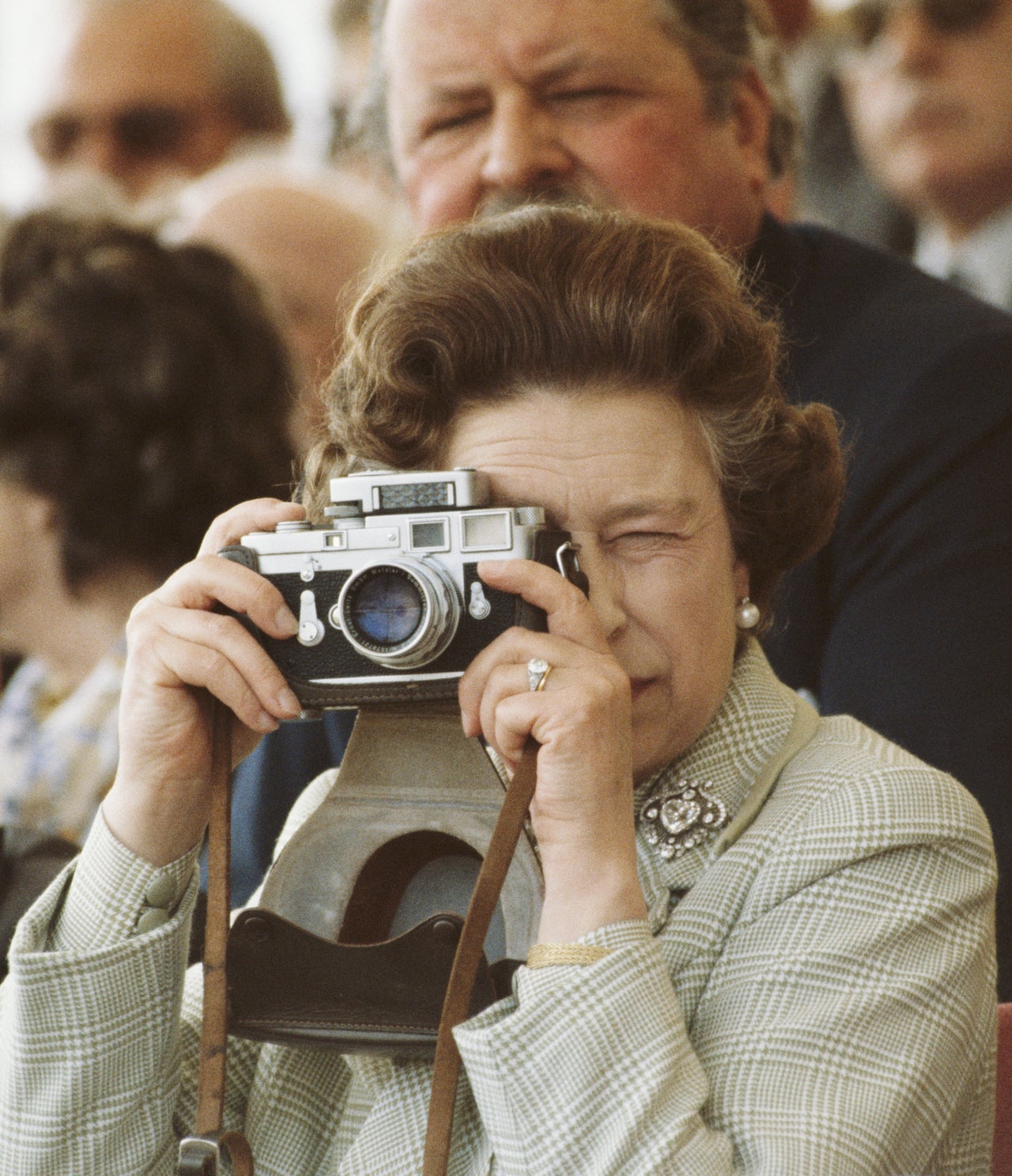 Queen Elizabeth II takes photos of her husband at the Windsor Horse Show on May 16, 1982.