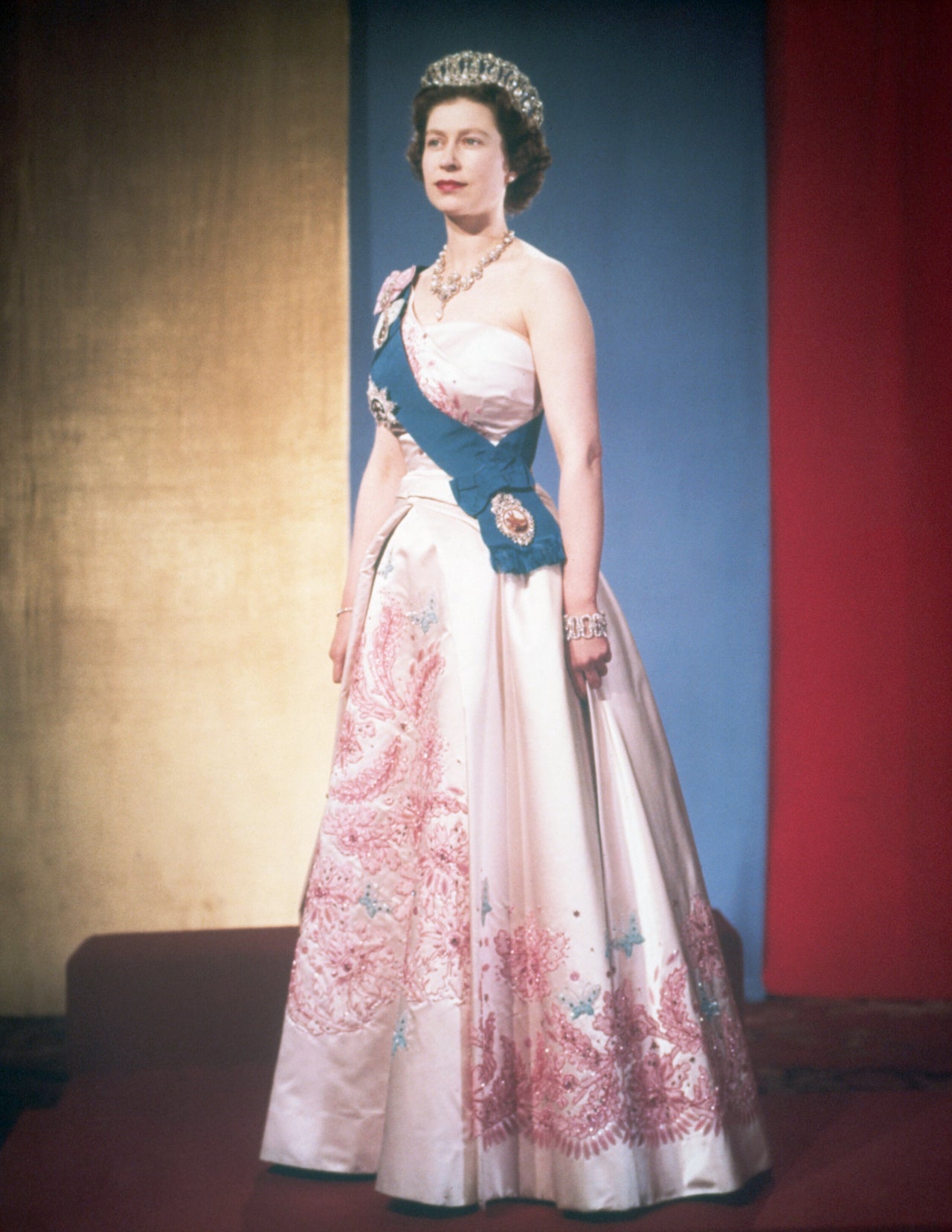 Queen Elizabeth II wearing her family's orders and orders of her kingdom on the sash over her shoulder, along with several items of family jewelry.