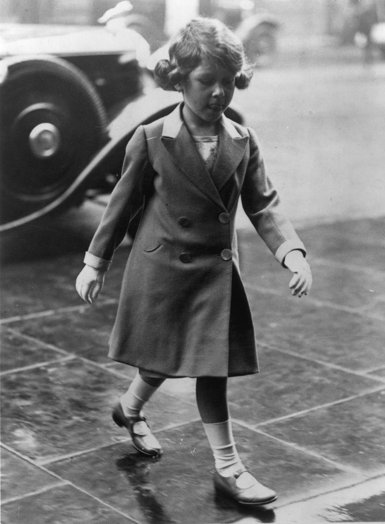 Princess Elizabeth walks in to visit the Royal Tournament at Olympia in 1932. 