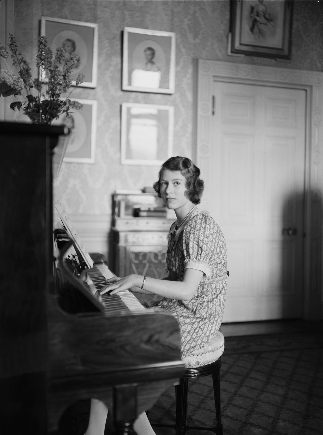 Princess Elizabeth playing a piano at Windsor Castle in 1940.
