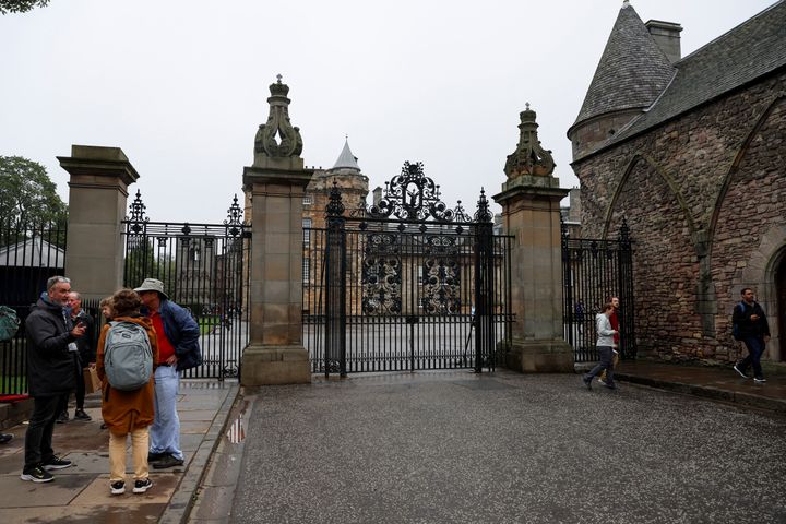 People gather outside the Palace of Holyroodhouse following a statement from the Buckingham Palace over concerns for Britain's Queen Elizabeth's health, in Holyrood, Edinburgh, Scotland, Britain September 8, 2022. REUTERS/Lee Smith