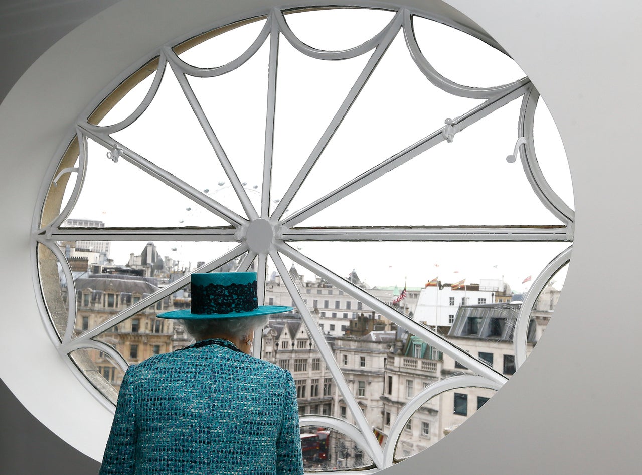 Queen Elizabeth II looks at the view out of a window during a visit to reopen Canada House on Feb. 19, 2015. 