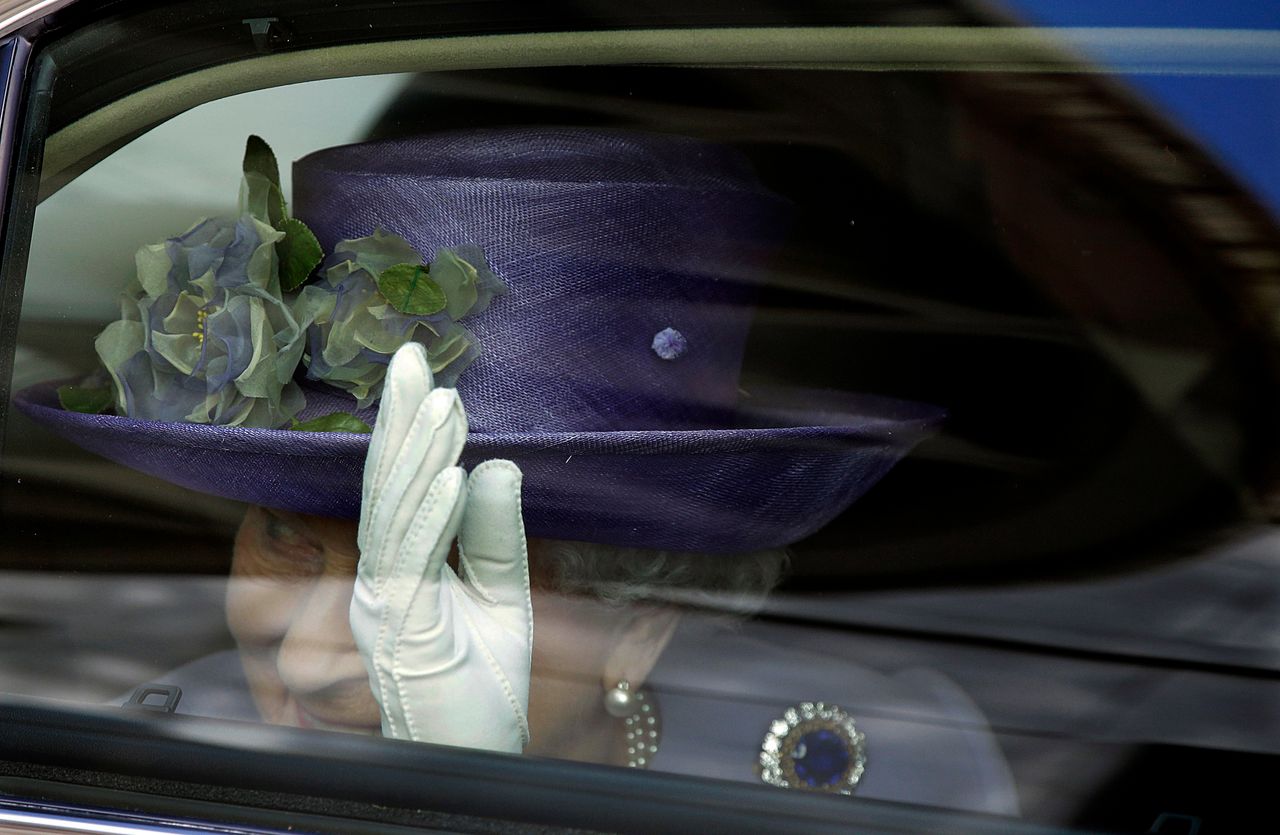 Britain's Queen Elizabeth waves to Pope Francis at the end of their meeting at the Vatican on April 3, 2014. 