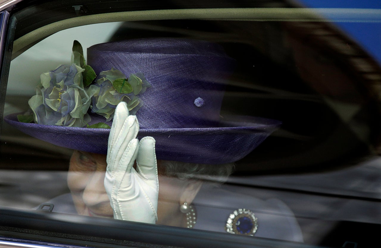 Britain's Queen Elizabeth waves to Pope Francis at the end of their meeting at the Vatican on April 3, 2014.