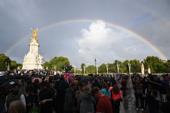 A faint rainbow is seen over a more vivid one outside of Buckingham Palace Thursday.