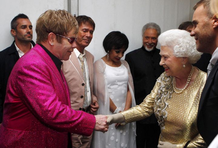 Queen Elizabeth II meets Sir Elton John backstage during the 2012 Diamond Jubilee Concert outside Buckingham Palace in London.