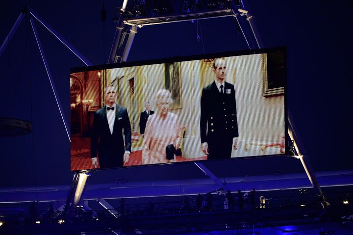 Queen Elizabeth II appears on a large video screen accompanied by Prince Philip, right, and actor Daniel Craig during the Opening Ceremony for the 2012 Summer Olympic Games