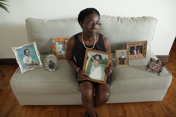 Marie Andre with photos of son George Desdunes