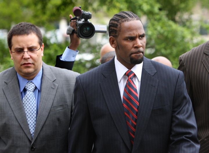 R. Kelly, center, arrives with manager Derrel McDavid, left, at the Cook County Criminal Courts Building in Chicago for his child pornography trial in 2008.