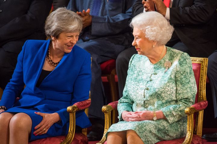 Former prime minister Theresa May sits with Queen Elizabeth II in 2018.