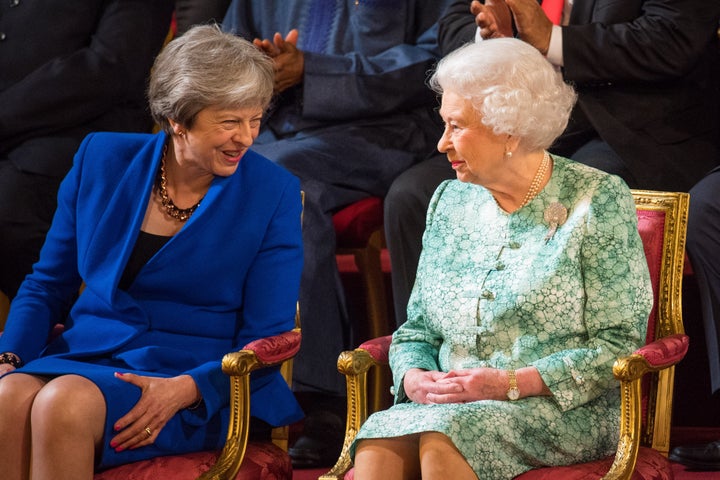 Former prime minister Theresa May sits with Queen Elizabeth II in 2018.