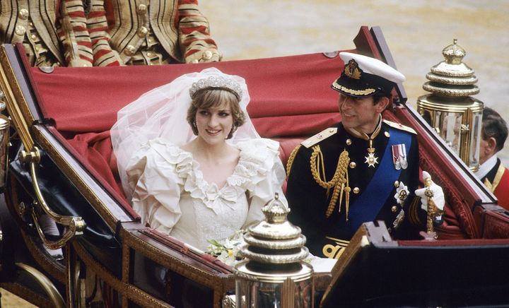  Prince Charles, Prince of Wales and Diana, Princess of Wales, wearing a wedding dress designed by David and Elizabeth Emanuel and the Spencer family Tiara, ride in an open carriage, from St. Paul's Cathedral to Buckingham Palace, following their wedding on July 29, 1981 in London, England.