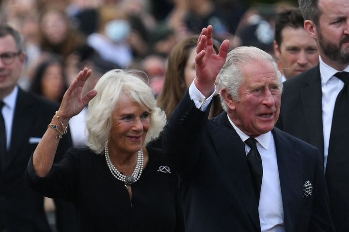 King Charles III and Camilla, Queen Consort wave as they greet the crowd upon their arrival Buckingham Palace in London, on Sep. 9, a day after Queen Elizabeth II died at the age of 96. 