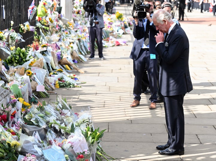 The king views floral tributes to the late Queen Elizabeth II outside Buckingham Palace on Sep 9. 