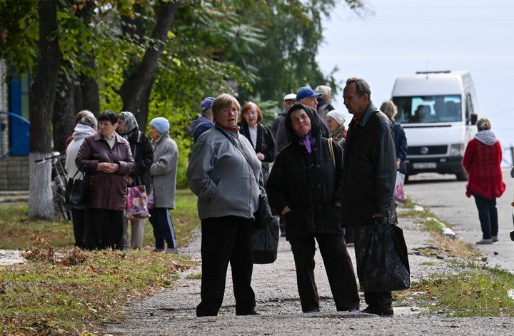 People walk in the street in Balakliya, Kharkiv region, on September 10, 2022, amid the Russian invasion of Ukraine. - Moscow's announcement alongside Kyiv's claim to have entered the town of Kupiansk are the most significant shifts in battlefield dynamics after months of fighting in eastern Ukraine that has been dominated by Moscow. 