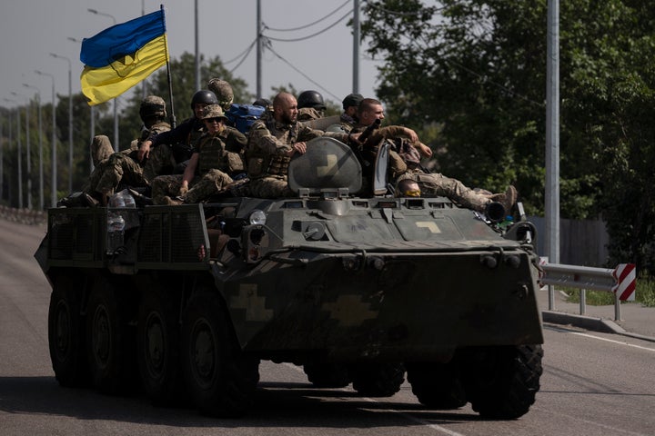 Ukrainian servicemen ride atop of an armored vehicle on a road in Donetsk region, eastern Ukraine, Sunday, Aug. 28, 2022. (AP Photo/Leo Correa, File)