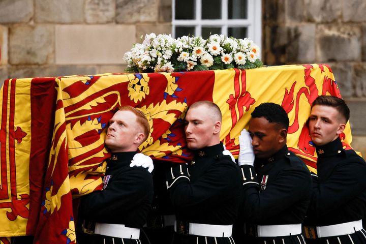 Pallbearers carry the coffin of late Britain's Queen Elizabeth II at the Palace of Holyroodhouse, in Edinburgh on September 11, 2022.