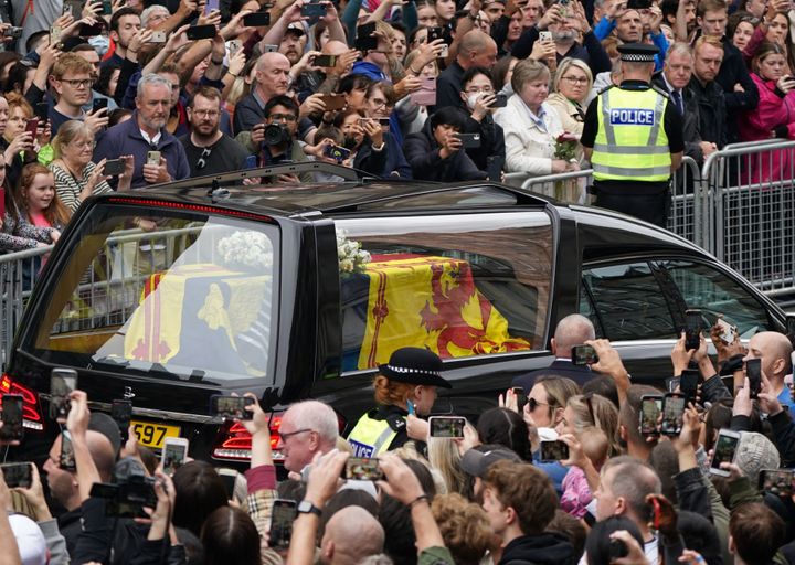 The coffin of Queen Elizabeth II, draped in the Royal Standard of Scotland, driven through Edinburgh.