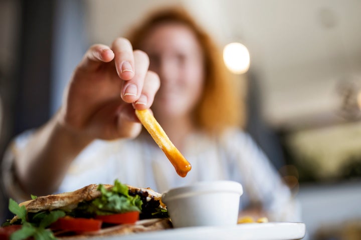 Dipping French fries in ketchup