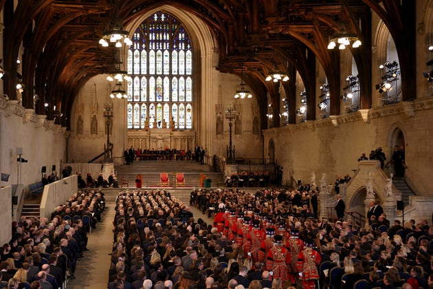 MPs, peers and other guests wait for the King and Queen Consort to arrive at Westminster Hall.