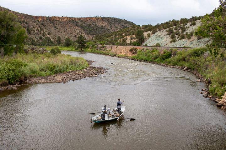 Fisherman on a boat float on the Colorado River, June 27, 2021, near Burns, Colo. In November 1922, seven land-owning white men brokered a deal to allocate water from the Colorado River, which winds through the West and ends in Mexico. During the past two decades, pressure has intensified on the river as the driest 22-year stretch in the past 1,200 years has gripped the southwestern U.S.
