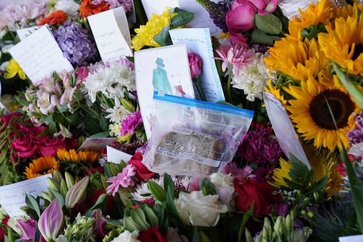A marmalade sandwich with a note that says "A marmalade sandwich for your journey, Ma'am" a nod to the Queen's association with Paddington Bear, left among the flowers laid by members of the public at Balmoral in Scotland.
