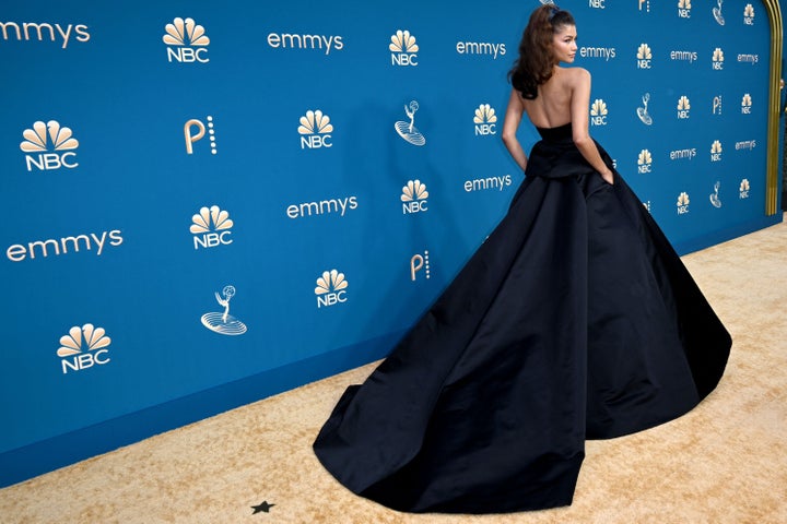 Zendaya rocked an all-black Valentino gown astatine the 2022 Emmy Awards reddish carpet connected Monday.