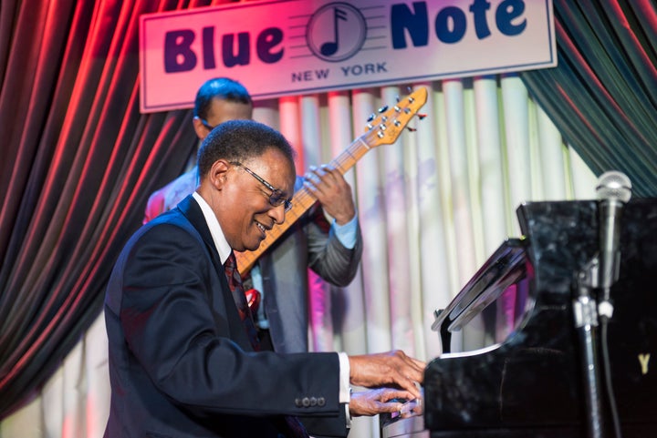 American Jazz musician Ramsey Lewis plays piano as he leads his quartet on stage at the Blue Note, New York, New York, January 18, 2015. Behind him is Joshua Ramos on bass guiter. (Photo by Jack Vartoogian/Getty Images)