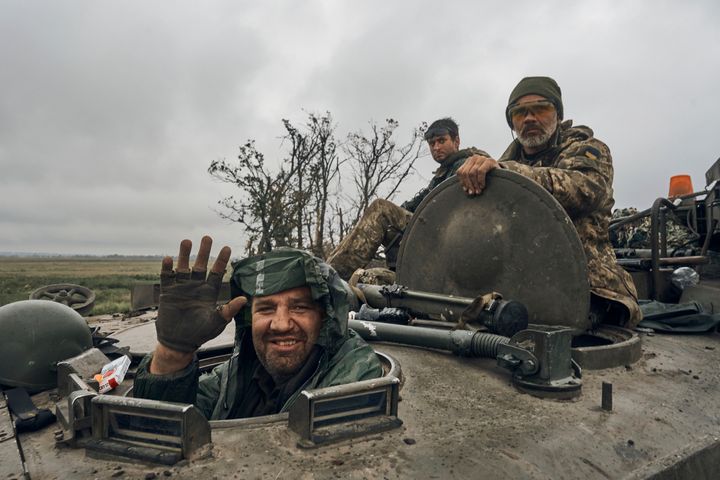 A Ukrainian soldier smiles from a military vehicle on the road in the freed territory in the Kharkiv region, Ukraine, on Sept. 12, 2022. Ukrainian troops retook a wide swath of territory from Russia on Monday, pushing all the way back to the northeastern border in some places, and claimed to have captured many Russian soldiers as part of a lightning advance that forced Moscow to make a hasty retreat. 