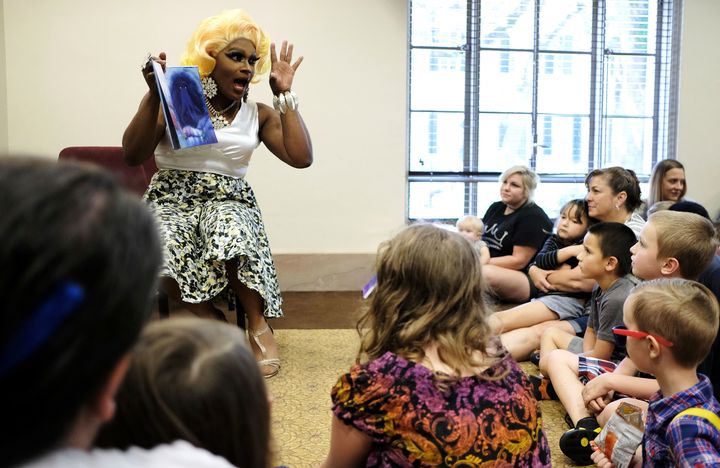 Drag performer Champagne Monroe reads a children's book titled "Rainbow Fish" to a group of kids and parents at the Mobile Public Library in Mobile, Alabama, in 2018.